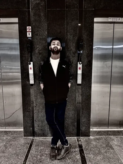 Portrait in a lift lobby, in black and white