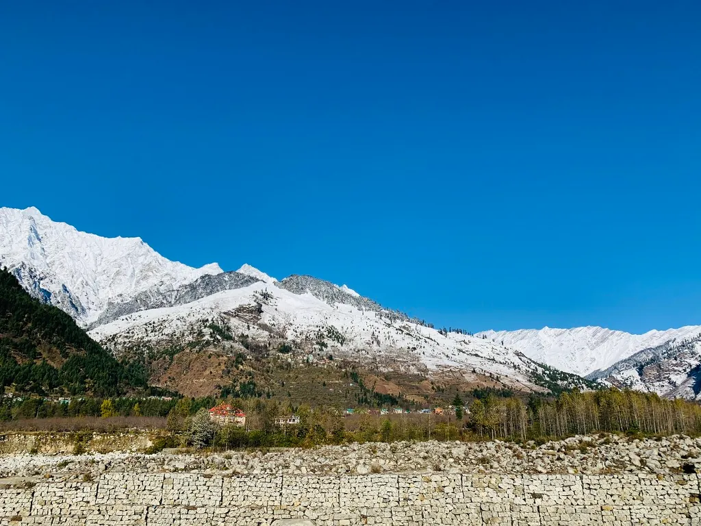 Snow-covered peaks under a deep blue sky