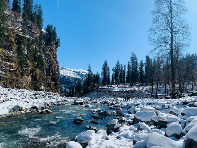 A river running between snow-covered stones