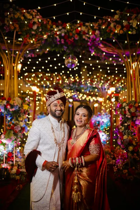 The two of us at our wedding, under fairy lights and flowers